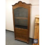 A continental mahogany glazed cabinet on scroll feet,