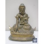 An antique lacquered brass figure of an Eastern deity