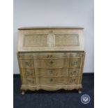 A blond oak serpentine fronted bureau