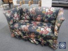 An early 20th century two seater settee in floral fabric and two scatter cushions