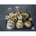 A tray of brass candlesticks,