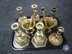 A tray of brass candlesticks,