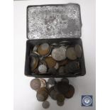 An antique tin containing a quantity of copper and other coins