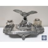 A late Victorian silver plated desk stand mounted with an eagle and two glass inkwells