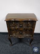 A carved pine shaped front two drawer chest