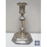 A silver candlestick on octagonal base