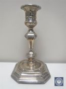 A silver candlestick on octagonal base