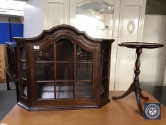A mahogany glazed door wall mounted curio cabinet and a wine table