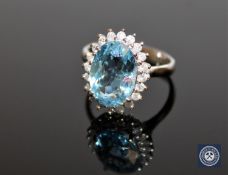 A 14ct white gold aquamarine and diamond cluster ring,