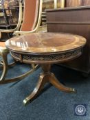 A circular mahogany occasional table on three-way pedestal support