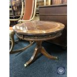 A circular mahogany occasional table on three-way pedestal support