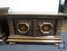 An early 20th century carved oak double door sideboard