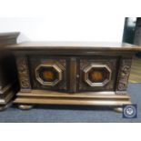 An early 20th century carved oak double door sideboard