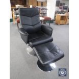 A black leather swivel armchair with footstool on chrome base