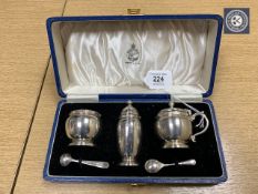 A Lindisfarne silver three-piece cruet set, with spoons, retailed by Reid & Sons Ltd.