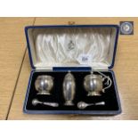 A Lindisfarne silver three-piece cruet set, with spoons, retailed by Reid & Sons Ltd.
