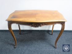 A shaped walnut table on cabriole legs