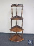 A reproduction mahogany Victorian style four tier corner what not stand