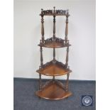 A reproduction mahogany Victorian style four tier corner what not stand