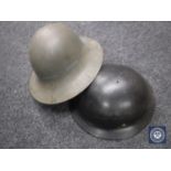 Two WW II helmets.