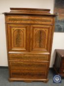 A continental mahogany double door cabinet fitted with four drawers,