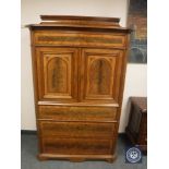 A continental mahogany double door cabinet fitted with four drawers,