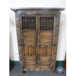 A 20th century Eastern hardwood double door cabinet
