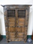 A 20th century Eastern hardwood double door cabinet