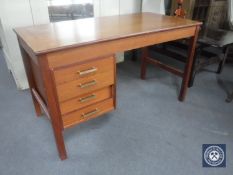 A mid 20th century teak desk fitted four drawers