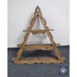 A carved oak triangular wall shelf