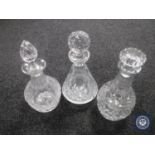 Three crystal decanters with stoppers