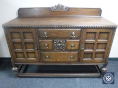 An early 20th century carved oak sideboard