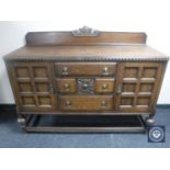 An early 20th century carved oak sideboard