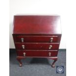 A stained 20th century bureau on claw and ball feet