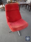 A 20th century swivel chair in a red cord fabric on chrome base