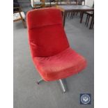 A 20th century swivel chair in a red cord fabric on chrome base