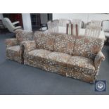 A mid 20th century three seater settee and armchair in floral fabric