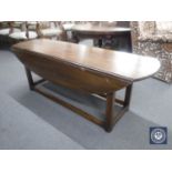 A narrow mahogany drop leaf coffee table