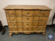 A 19th century oak serpentine front chest of four drawers,