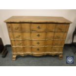 A 19th century oak serpentine front chest of four drawers,