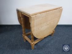 A stripped pine drop leaf table