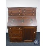 A Victorian pine bureau fitted ten drawers and a cupboard,