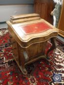 A 19th century walnut Davenport with red tooled leather top,