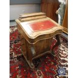 A 19th century walnut Davenport with red tooled leather top,