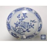 A nineteenth century Chinese blue and white plate decorated with song bird on flowers, diameter 27.