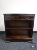 A set of inlaid mahogany bookshelves fitted two drawers