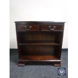 A set of inlaid mahogany bookshelves fitted two drawers