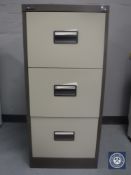 A three drawer metal filing cabinet