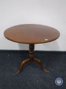 An antique mahogany occasional table