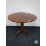 An antique mahogany occasional table